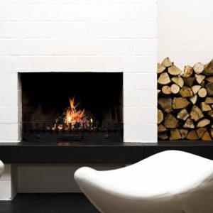 Fotoquelle AdobeStock fire-place with stacked wood, lounge chairs in front
